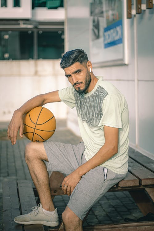 Handsome Man in T-Shirt Posing with Ball