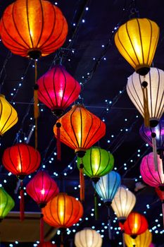 Vibrant and colorful Chinese lanterns beautifully illuminated against a night sky.