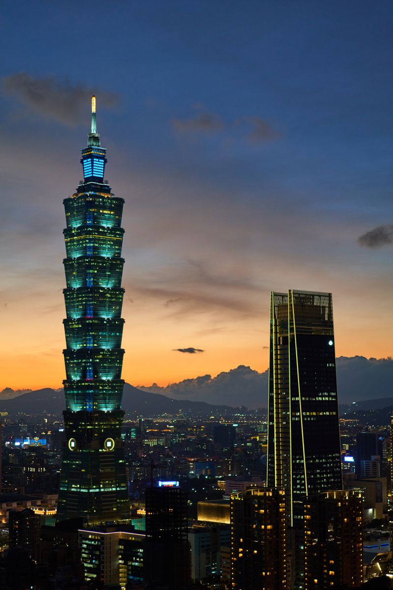 Taipei 101 tower glowing at dusk