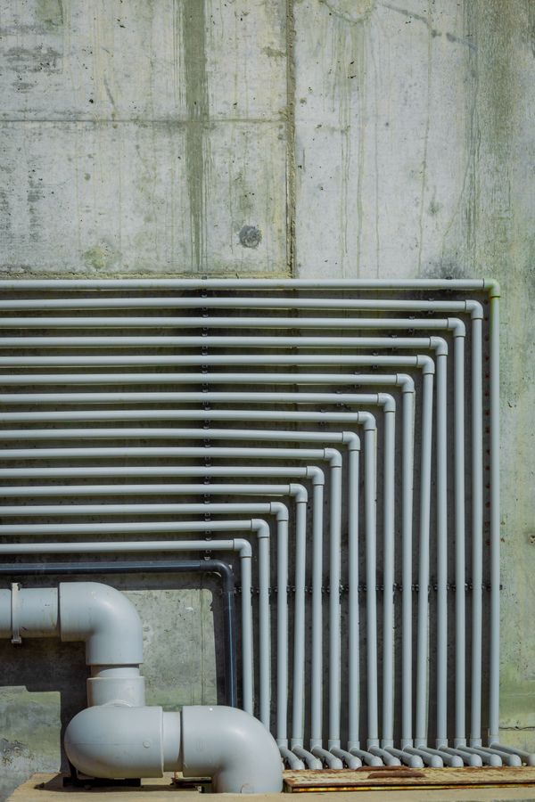 Industrial pipes against concrete wall