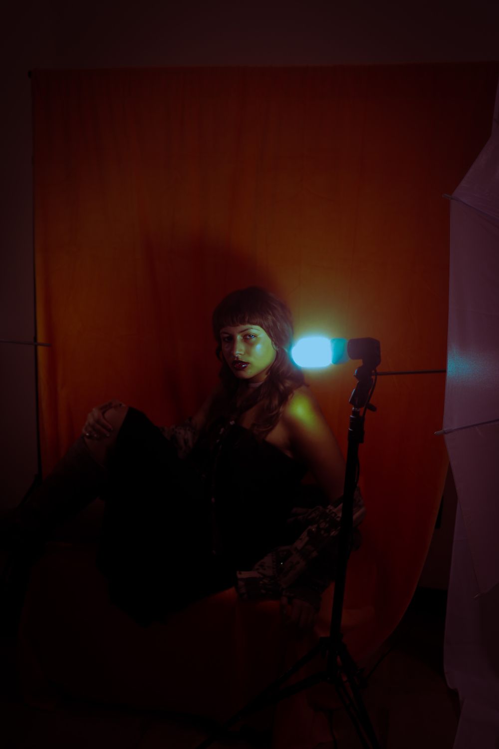 Dramatic studio portrait with orange lighting