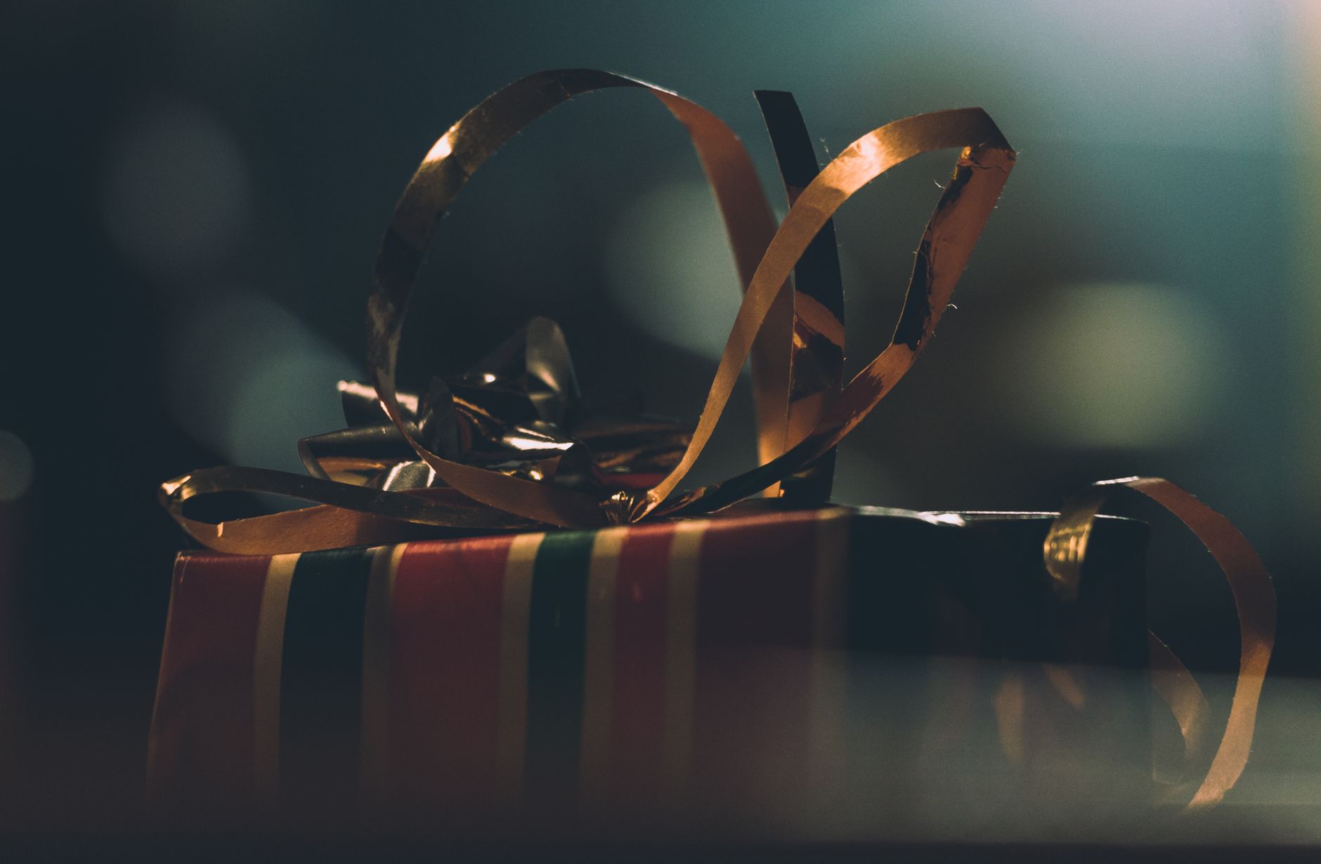 A close-up of a beautifully wrapped gift box with ribbons, perfect for holiday celebrations.