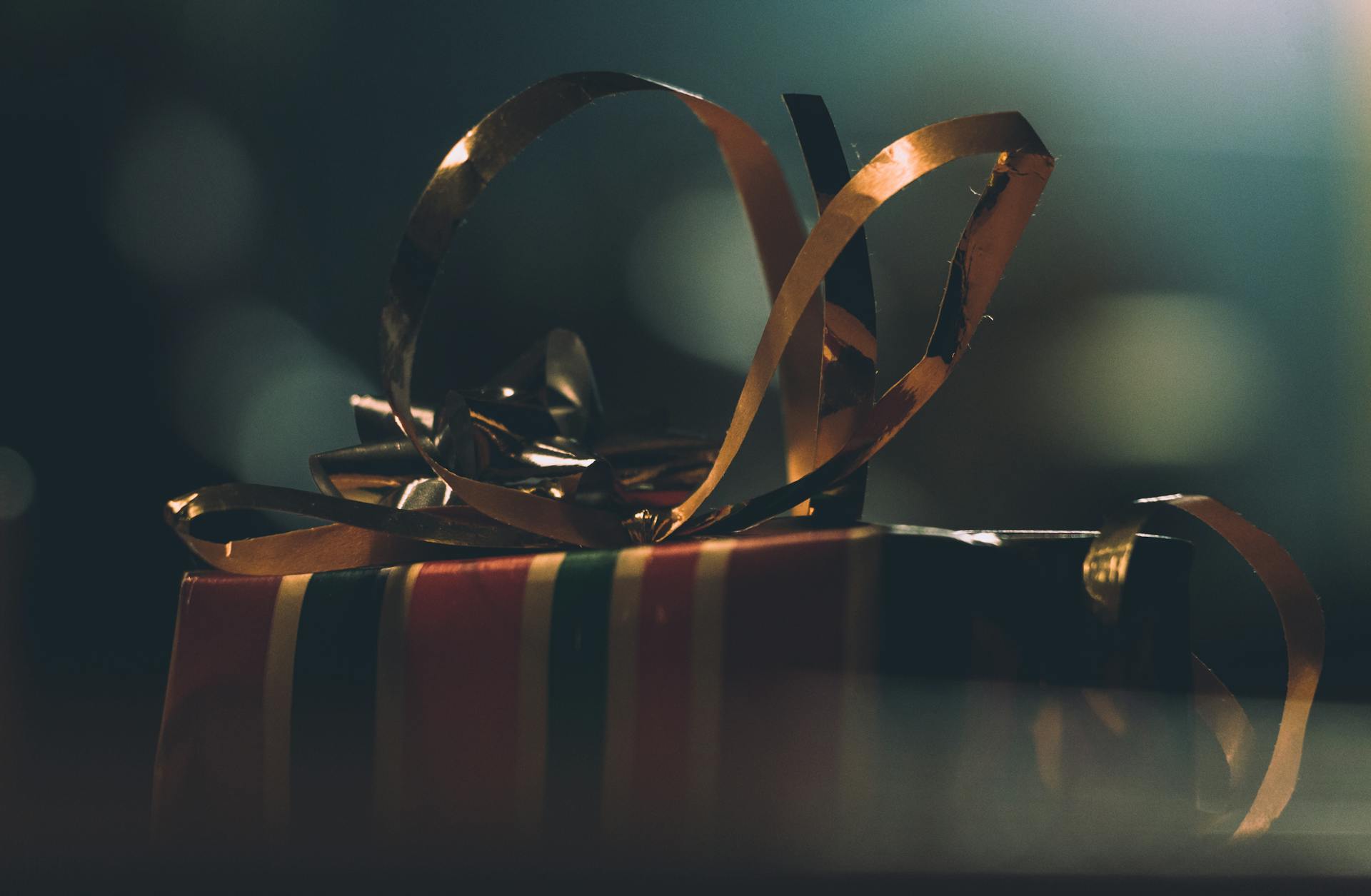 A close-up of a beautifully wrapped gift box with ribbons, perfect for holiday celebrations.