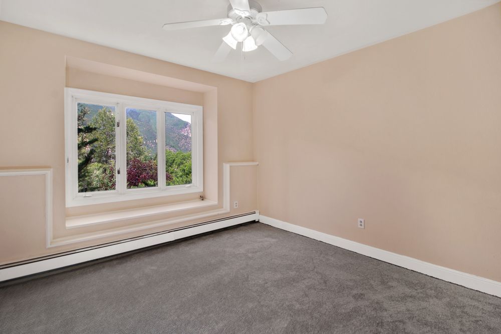 Unfurnished residential room with fitted wall-to-wall carpet and a window