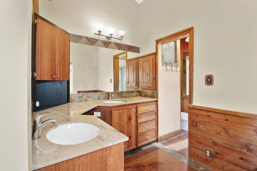 A Bathroom with Wooden Cabinets 