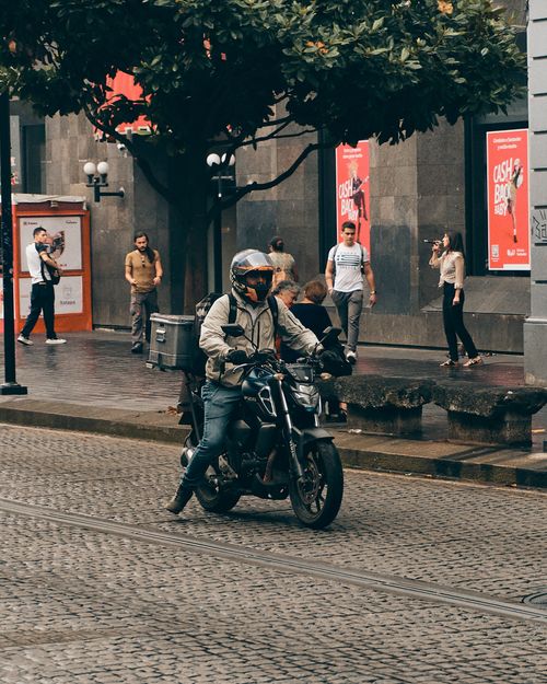 Free Motorcyclist riding through lively city streets in Xalapa, México, capturing urban life. Stock Photo