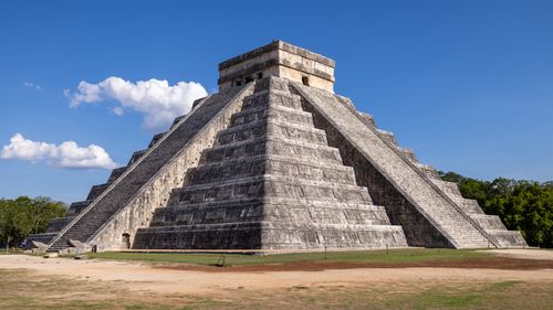 Free Explore the iconic El Castillo Pyramid under a clear blue sky at Chichén Itzá, Mexico. Stock Photo