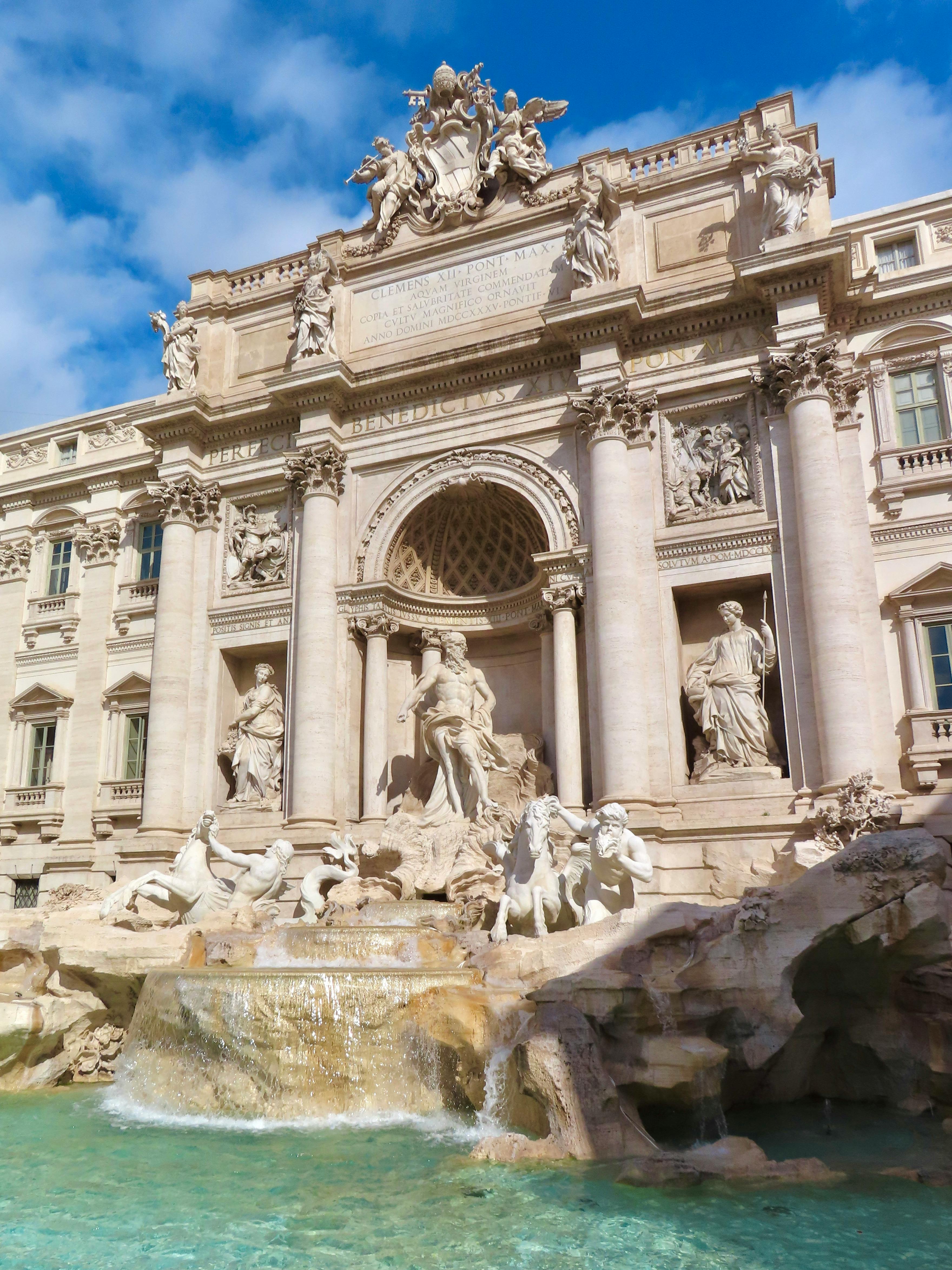 Low-angle Photo of Gray Concrete Building With Statues · Free Stock Photo