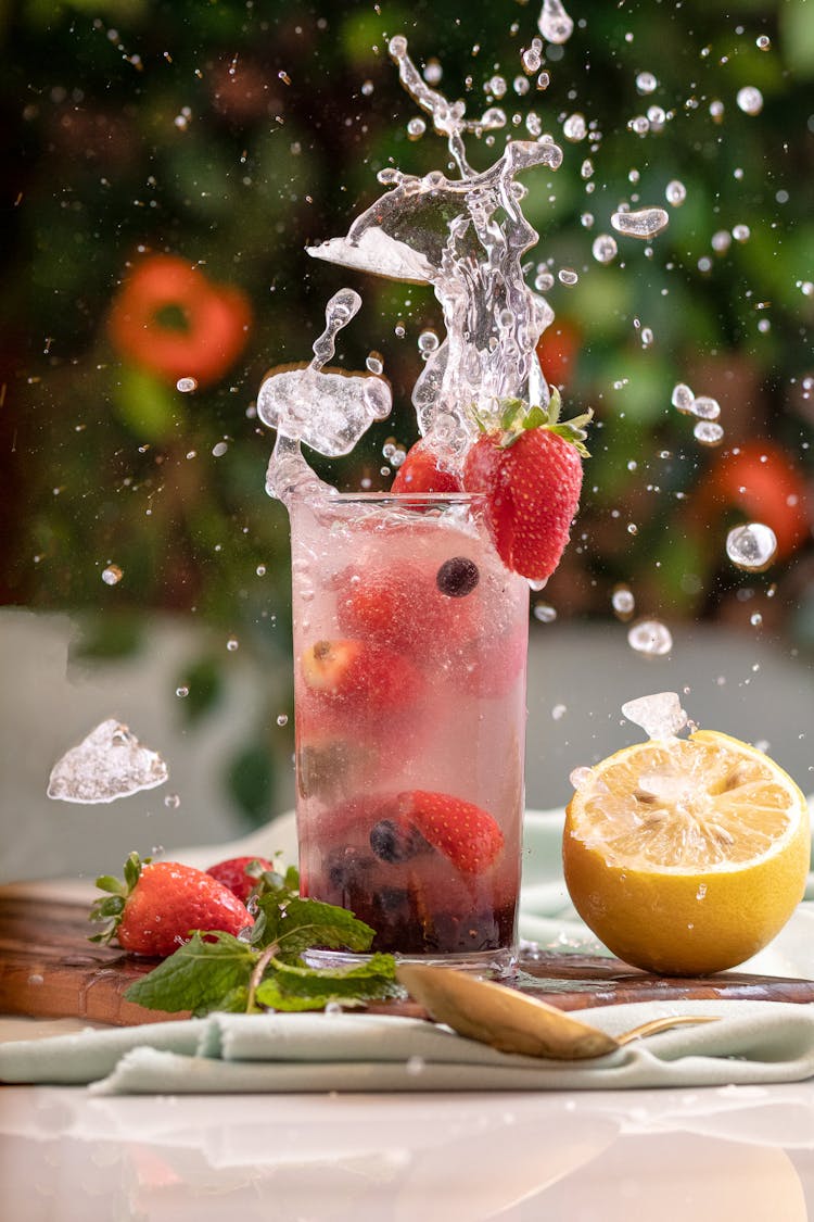 Photo Of A Glass With Splashing Water And Fruit