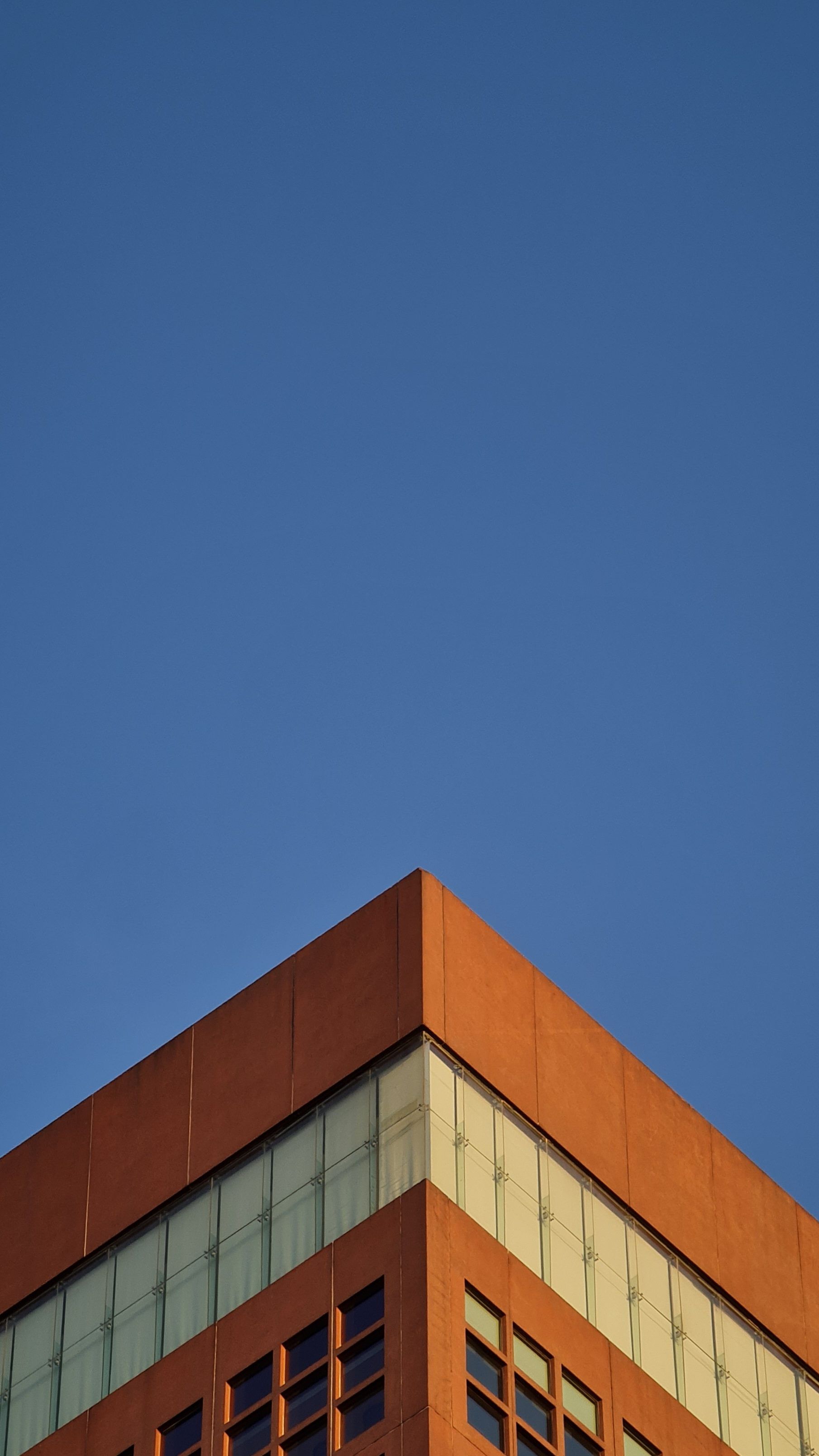 Clear Blue Sky over a Corner of a Building · Free Stock Photo