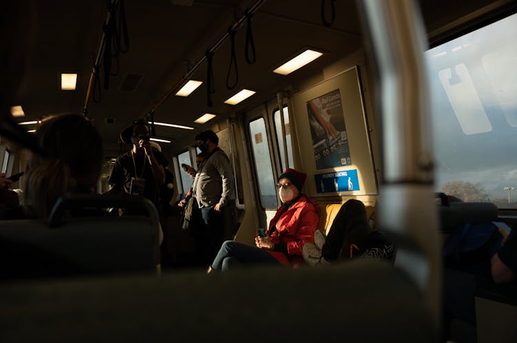 Woman In Medical Face Mask Travelling In Train