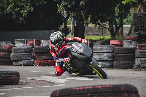 Racer on the Sports Bike Leaning into a Corner on a Race Track