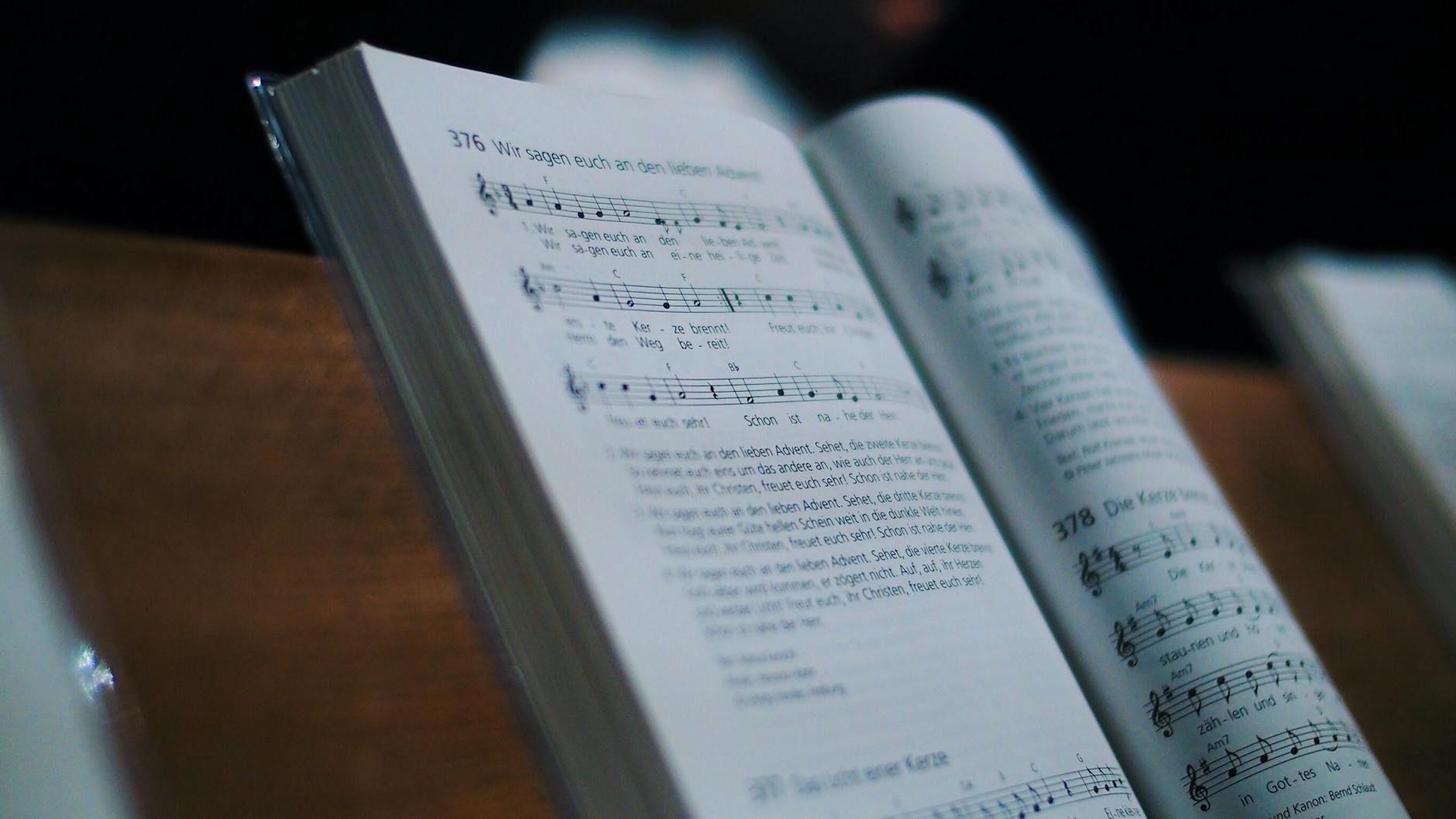 An open music book displaying sheet music and notations. Ideal for music and education themes.