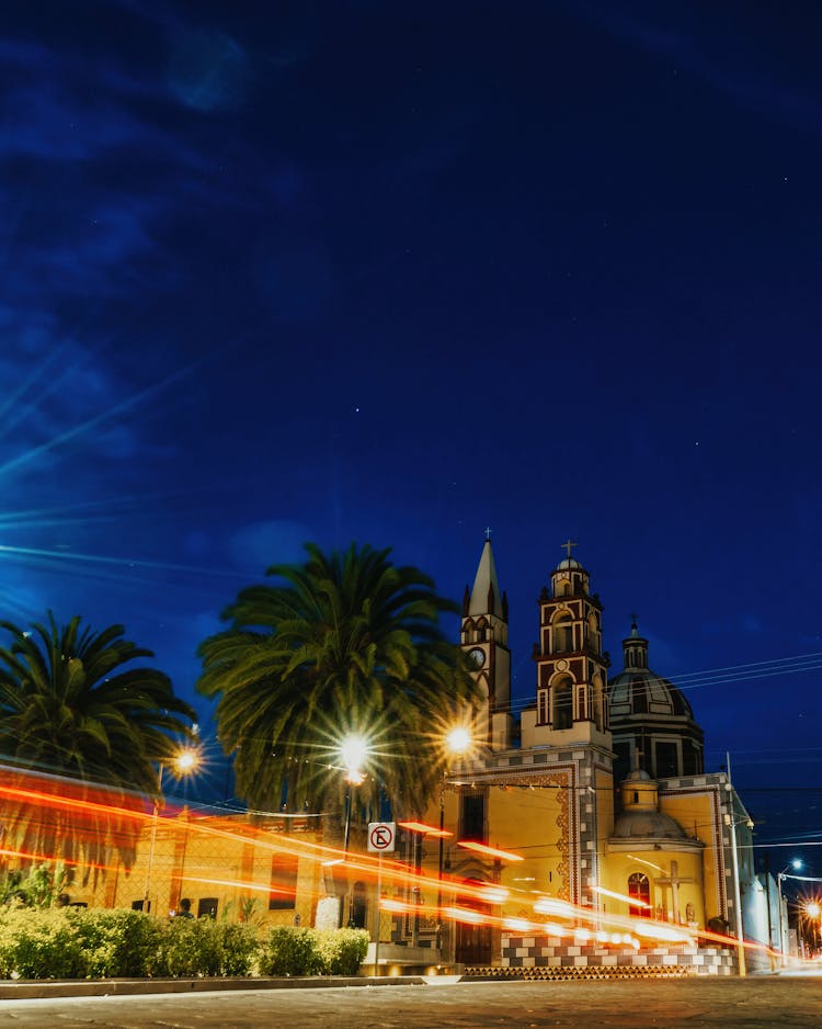 Vehicle Light Trails In Front Of The El Divino Salvador Parish At Night