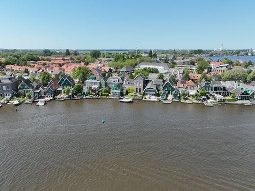 Free Scenic aerial view of traditional houses along the river in Zaandam, Netherlands. Stock Photo