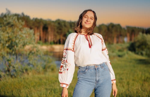 Young Woman in an Embroidered Folk Blouse and Jeans