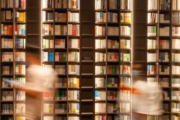 Ghosts Of Customers In Front Of Bookshelves