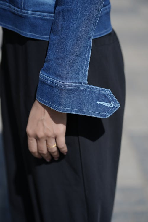 Close-up Photo of a Hand in a Denim Jacket
