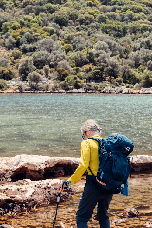 Hiker with a Backpack Walking by the River