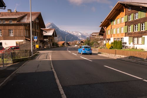 A Street between Buildings in a Town in a Valley with View of Mountains in Distance 