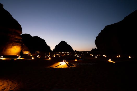 Experience the magical desert landscape of AlUla at dusk, beautifully lit by lanterns.