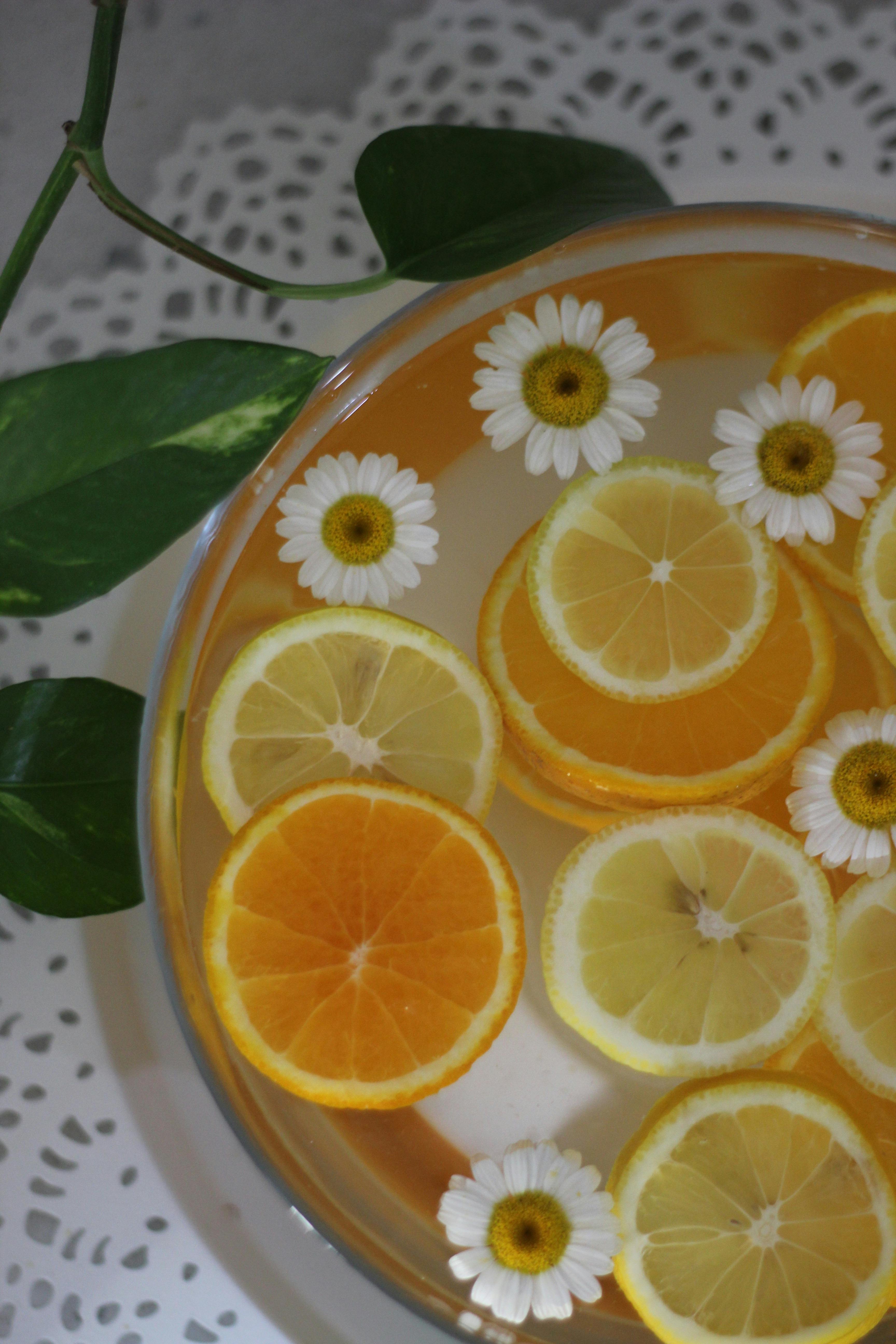 Lemonade with Flowers and Orange and Lemon Slices · Free Stock Photo