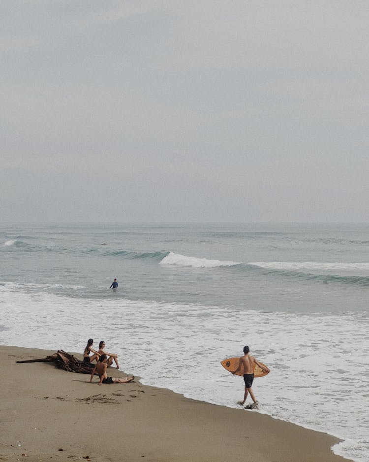 People On Beach Under Clouds