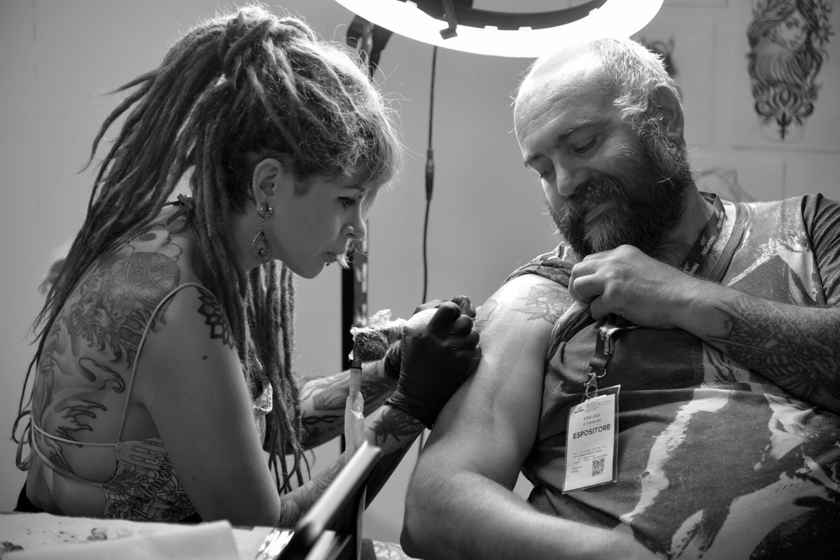Tattoo artist working in a studio