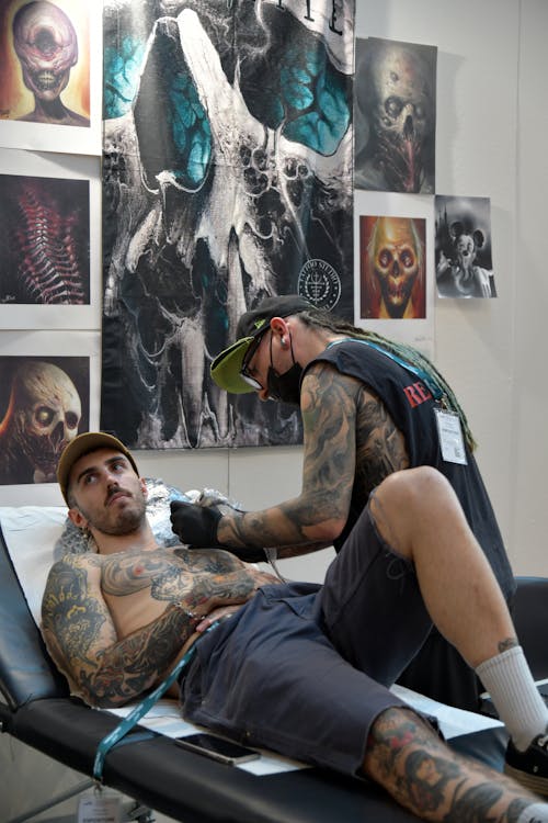 Tattoo Artist Tattooing a Young Man