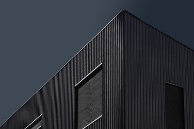 Dark themed modern architectural facade with geometric patterns under — Photo by REFARGOTOHP on Pexels