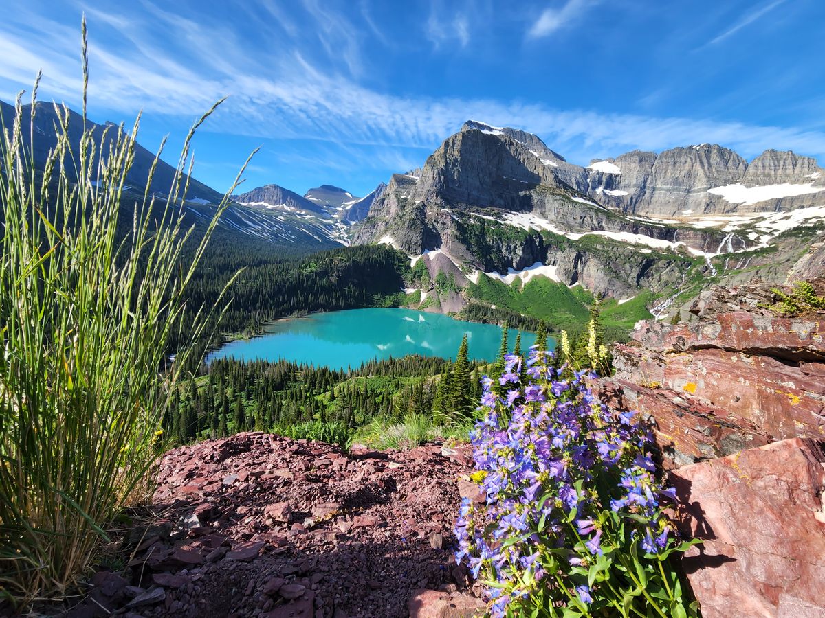 Turquoise lake below jagged peaks in Glacier National Park
