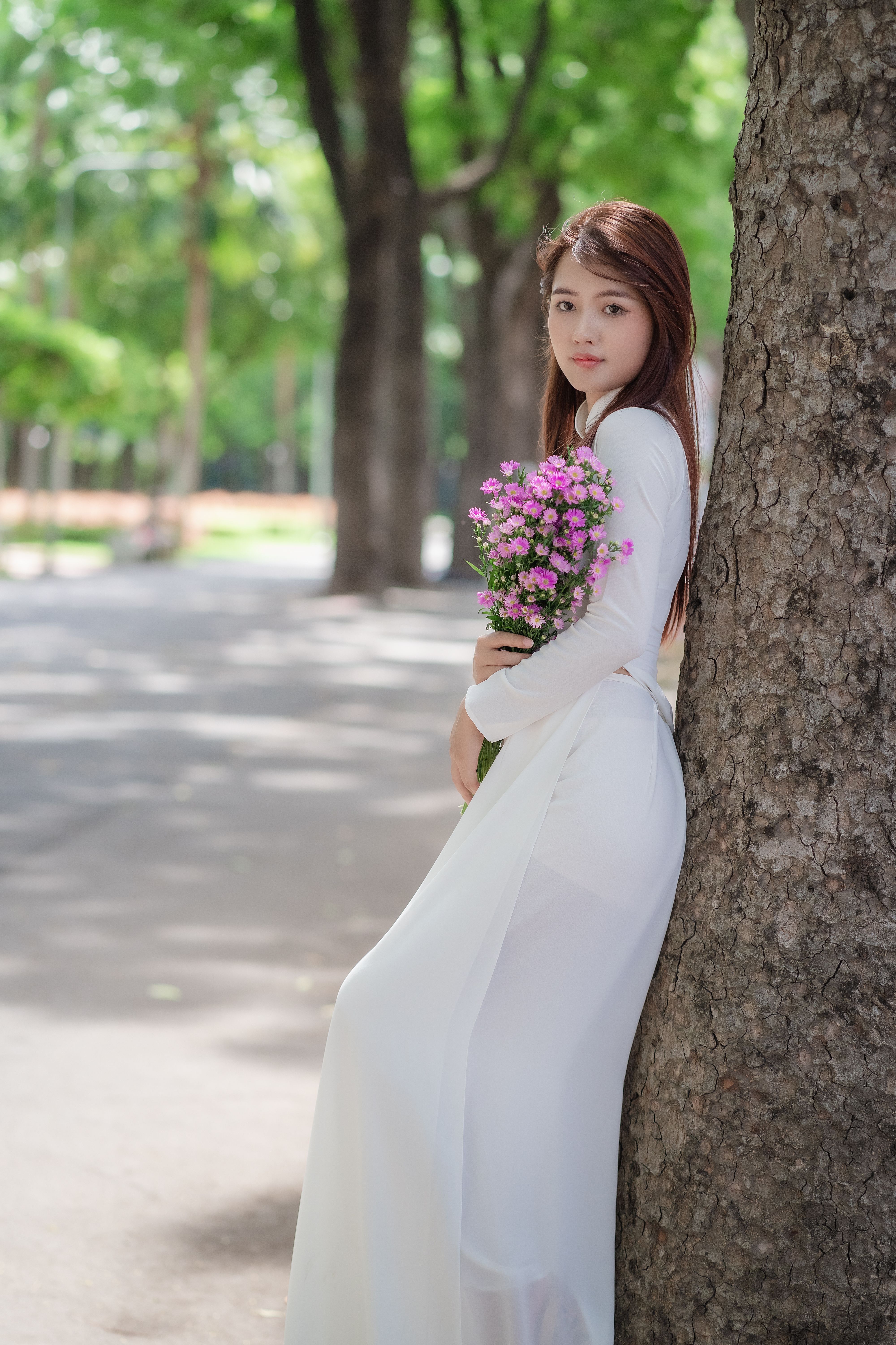 Beautiful Woman Standing with a Bouquet of Flowers in her Hands · Free ...