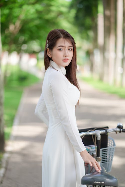 Beautiful Woman Standing with a Bicycle 