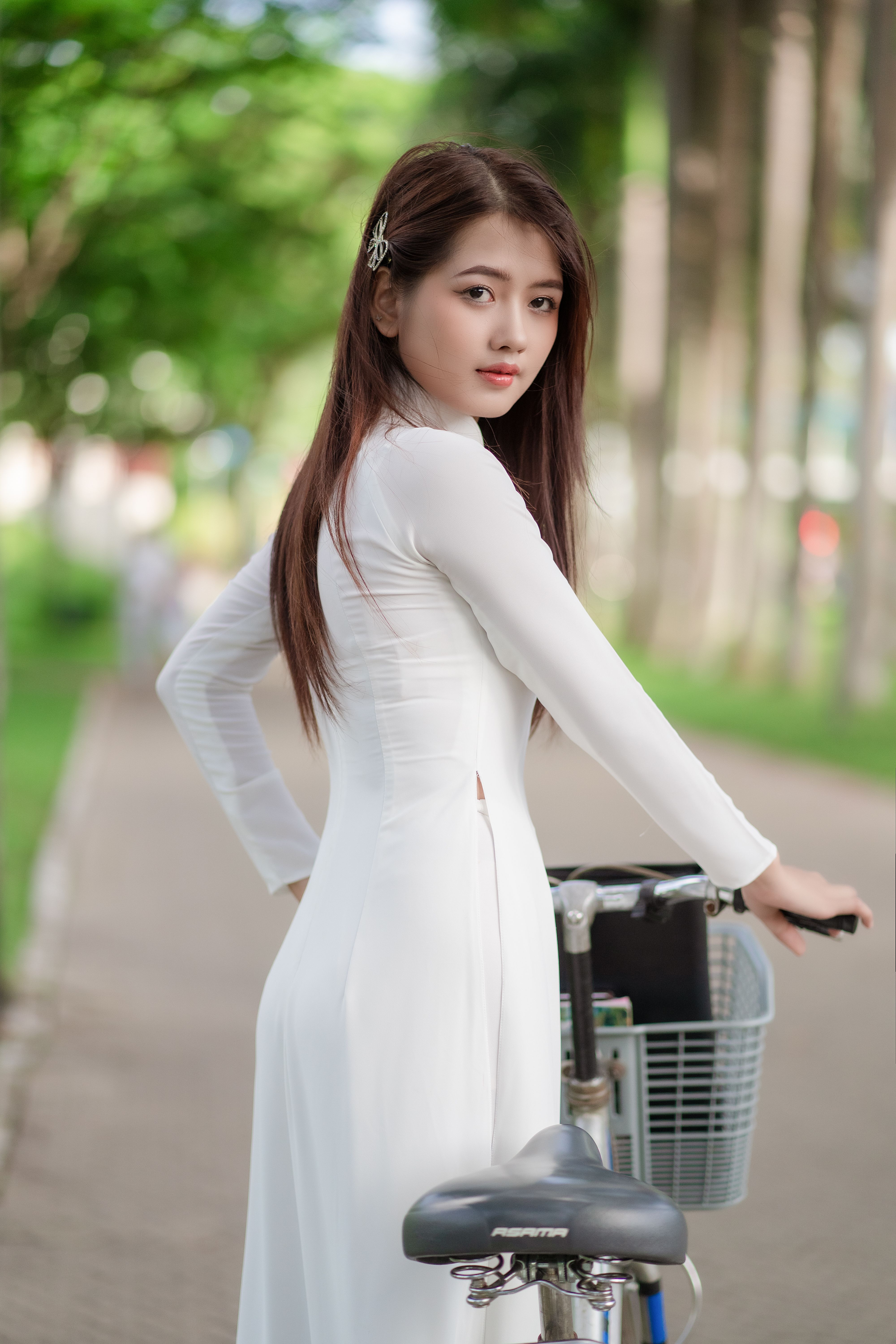 Photo of a Woman in a White Dress Sitting on a Bicycle · Free Stock Photo