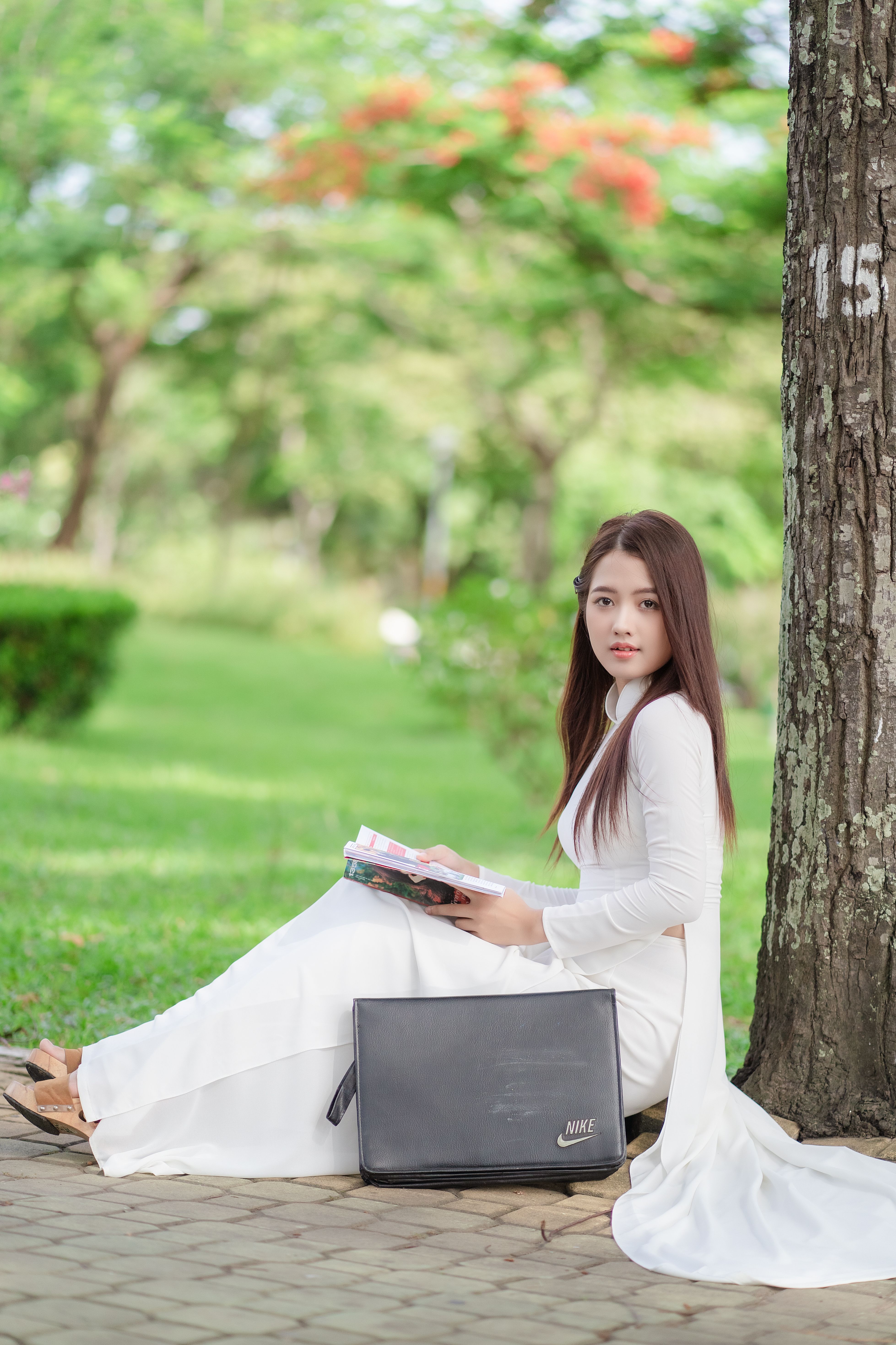Woman Sitting under a Tree and Reading a Book · Free Stock Photo