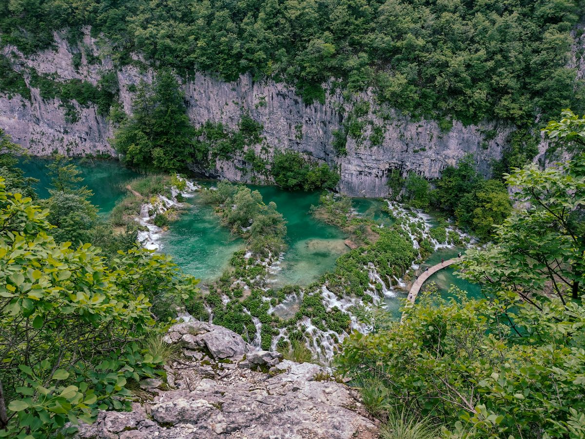 Explore the stunning emerald lakes and lush greenery of Plitvice Lakes in Croatia.
