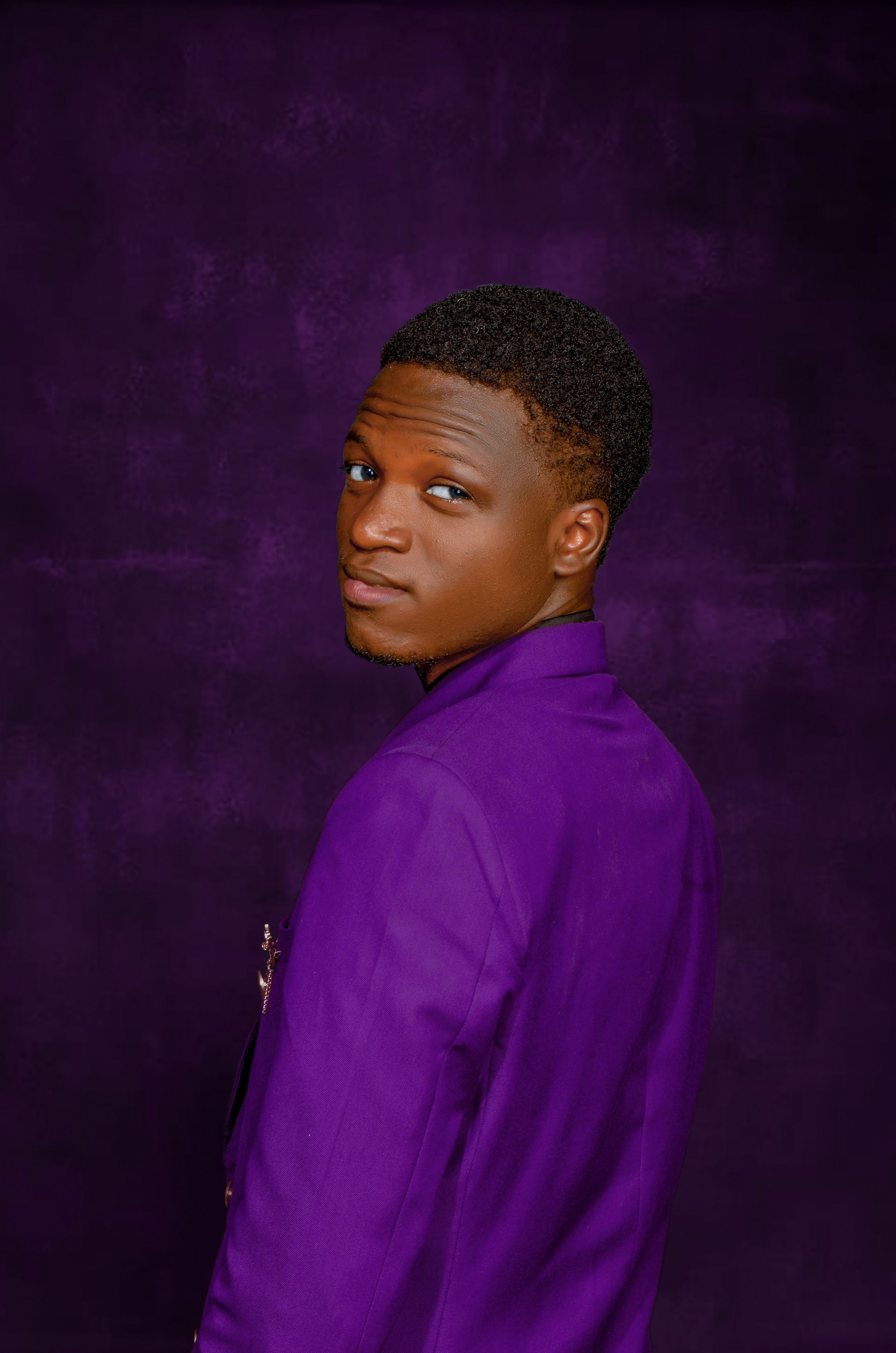 Free Studio portrait of a man wearing a purple jacket, showcasing elegance and style. Stock Photo