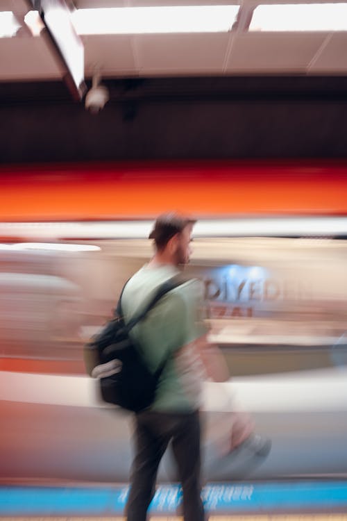 Blurred Man with Backpack at Railway Station Platform