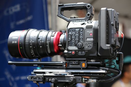 Close-up of a high-end professional video camera setup, ideal for film production.