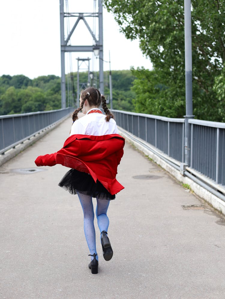 Woman With Braids Running On Bridge