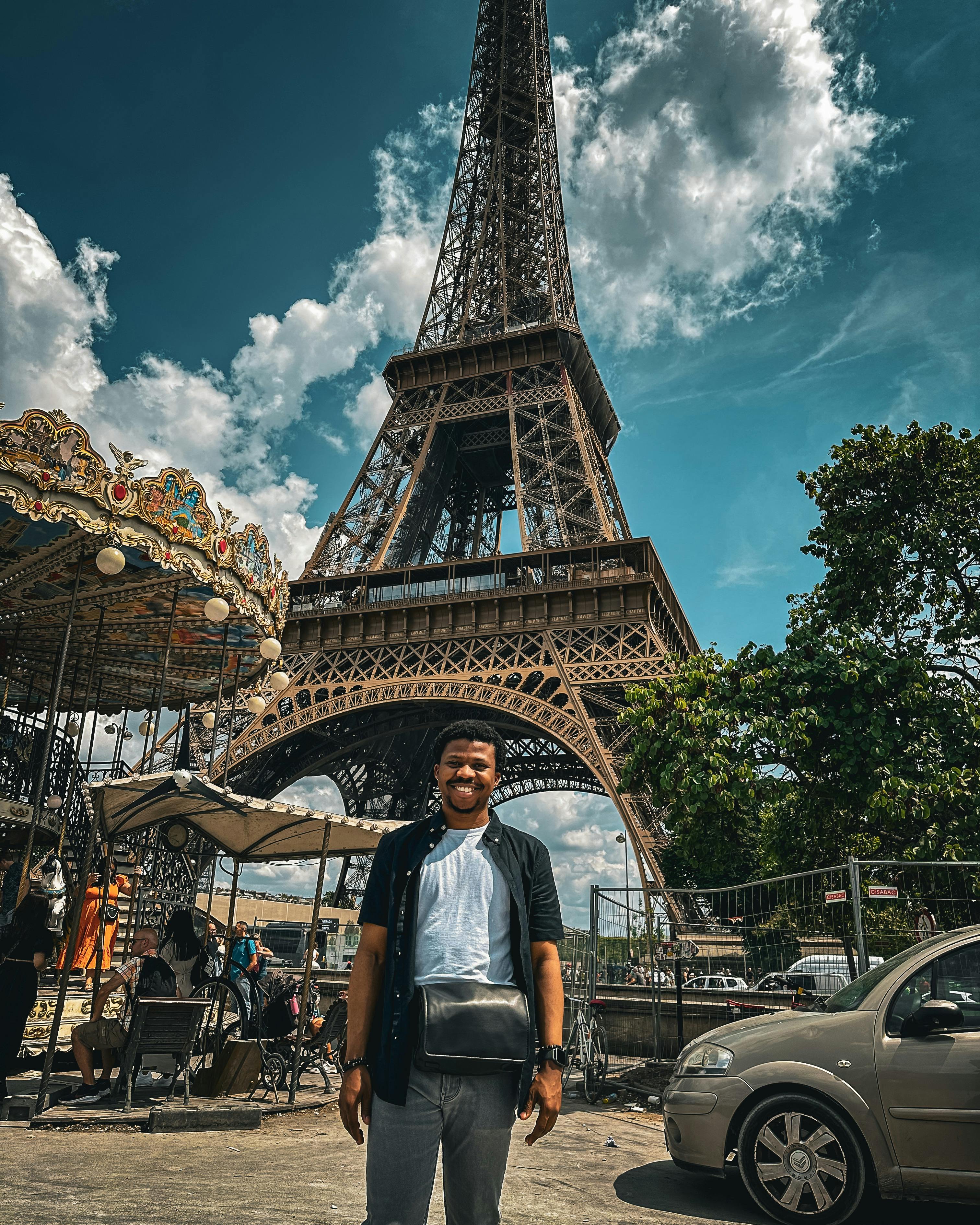 Beautiful Smiling Young Woman Poses with Her Arms in the Air for a Photo in  Paris with Eiffel Tower behind Her. Stock Photo | Adobe Stock