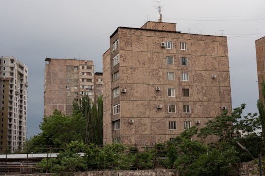 A view of urban apartment buildings with overcast skies, showcasing city architecture.
