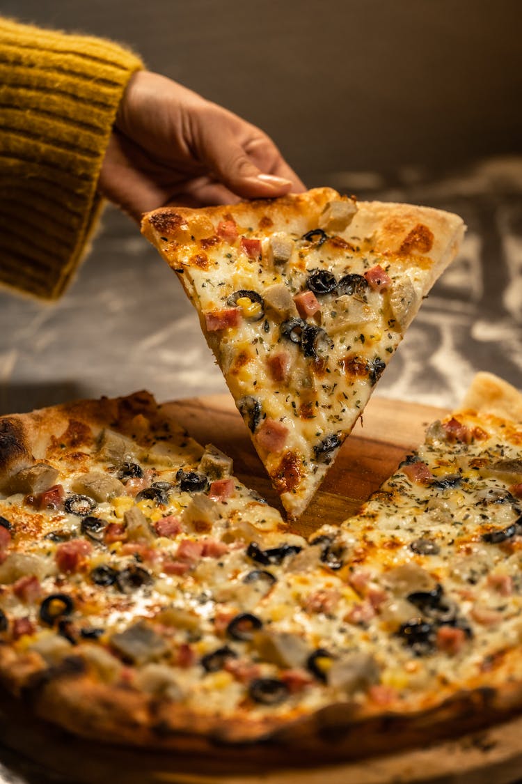 Woman Hand Holding Pizza