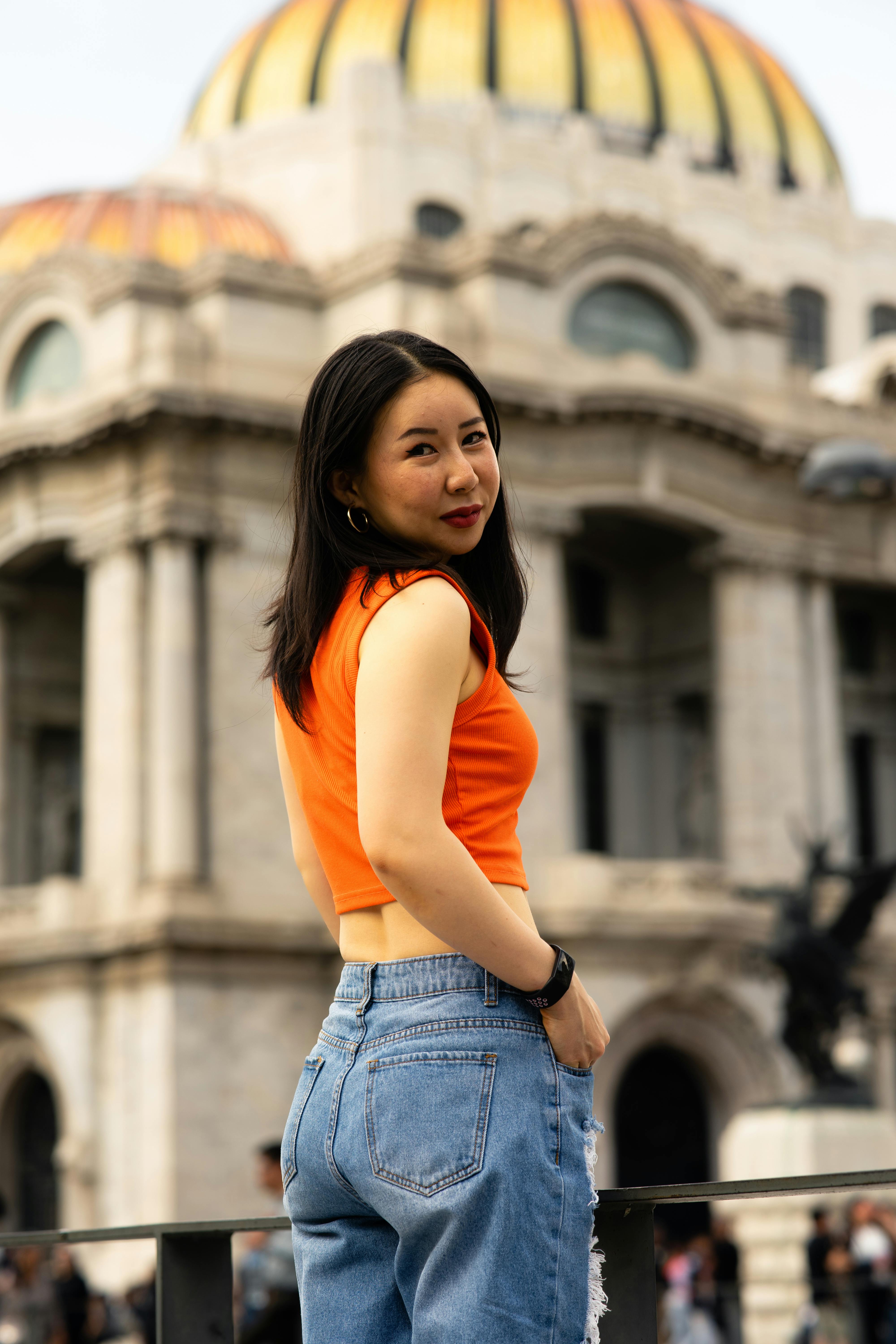 happy young asian woman visiting the streets of mexico city