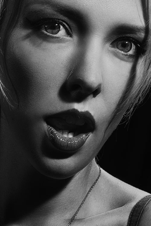 Free High contrast black and white portrait of a woman with an expressive, dramatic pose. Stock Photo