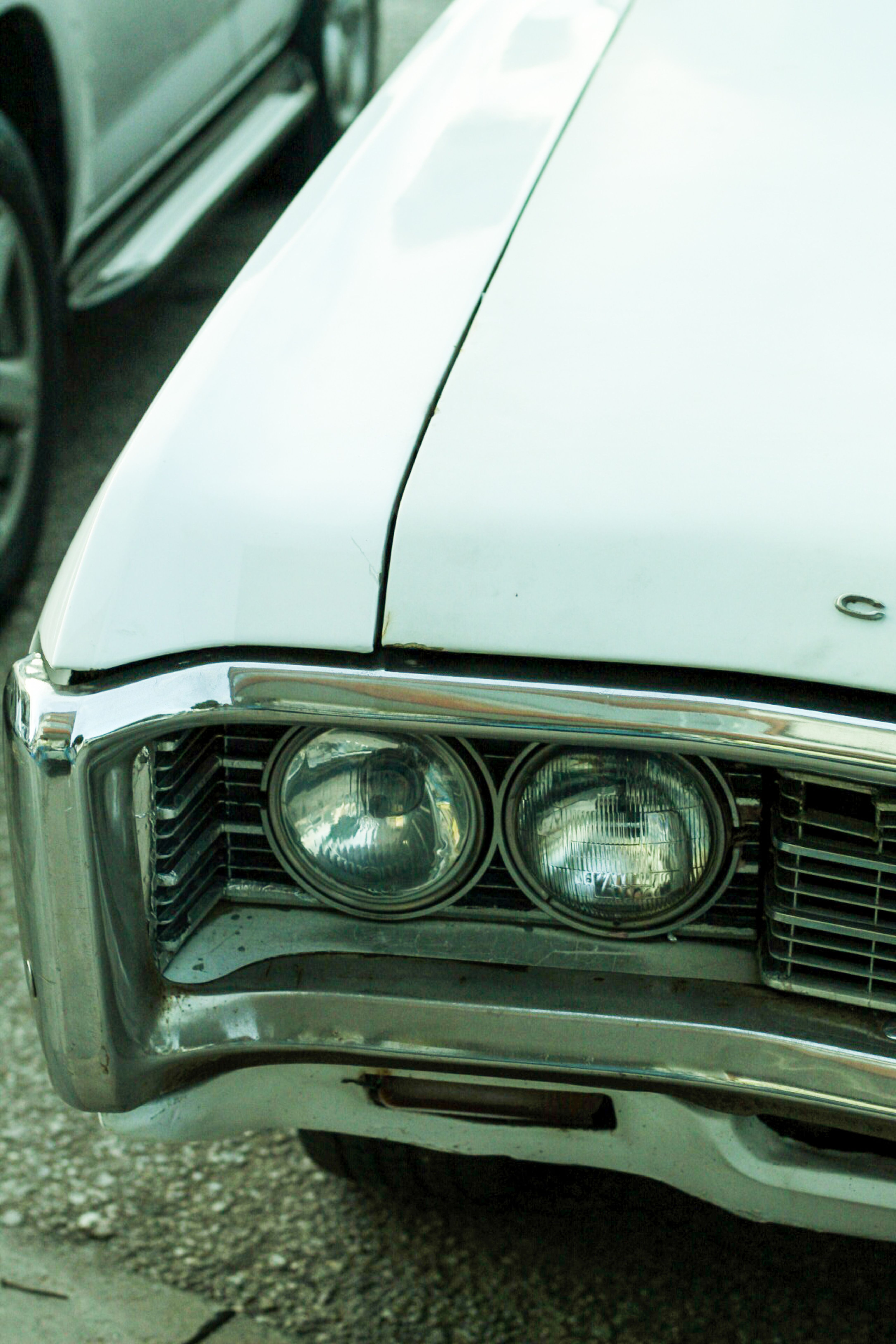 A close up of a vintage car with its headlights on · Free Stock Photo
