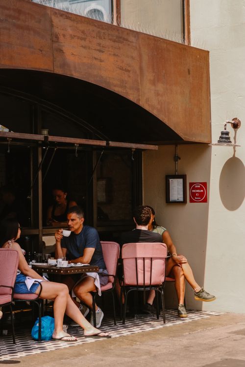 Free City street café scene with people enjoying coffee and leisure on a sunny day. Stock Photo