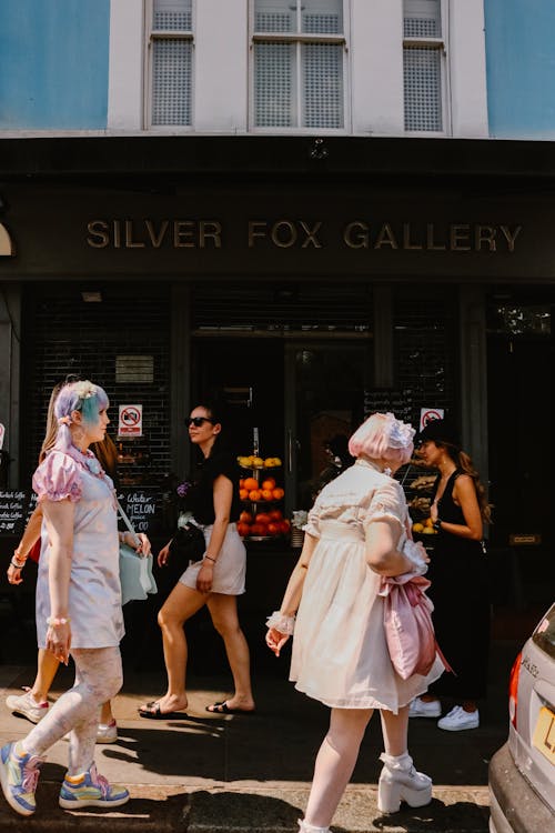 Girls in Cosplay Costumes on Sidewalk