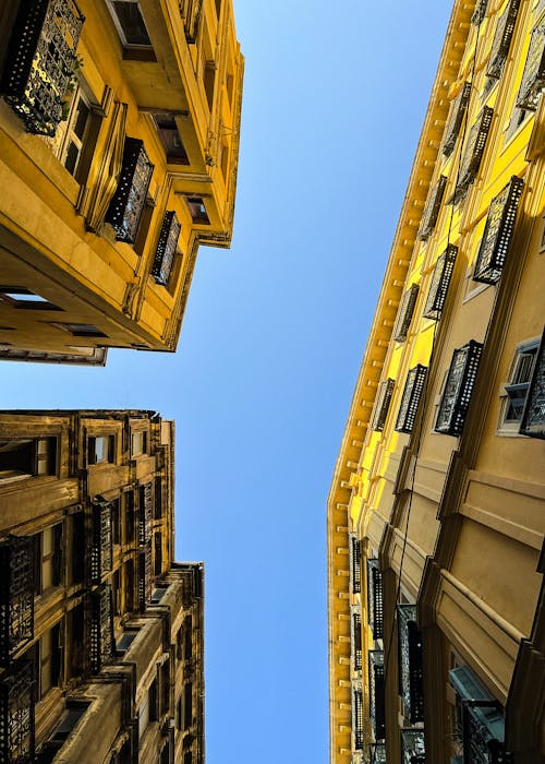 Low Angle Shot of Facades of Traditional Apartment Buildings under a Blue Sky 