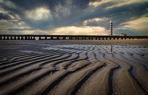 Free View of a Beach, Pier and Lighthouse in Lido di Jesolo, Italy  Stock Photo